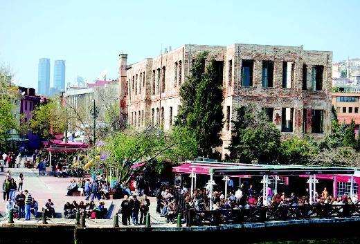 ESMA SULTAN YALISI Ortaköy Camii’ni geçtikten hemen sonra karşınıza çıkan Esma Sultan Yalısı’nı gözden kaçırmanız olanaksız. Yalı Sultan I. Abdülhamid’in kızı olan ve Çerkez Mehmed Paşa’yla evlenen Esma Sultan (1778-1848) için yapılmış. II. Mahmud’un kızkardeşi olan Esma Sultan enteresan bir kadın. Yazılanlara göre çok renkli bir hayat yaşayıp geride gözü yaşlı çok sayıda erkek bırakmış. Bu arada tarihte üç Esma Sultan olunca kaynaklarda yalının sahibinin hangisi olduğuyla ilgili farklı bilgiler var. Her yazarın ayrı bir Esma Sultan’ı var. Biz tercihimizi 1778 doğumlu olan için kullandık! Yalı önce okul, sonra tütün deposu, 1975’teki yangında harabeye dönmeden önce de kömür deposu olarak kullanılmış. 1990’larda buradaki kalıntılar The Marmara grubu tarafından alındı. Geride kalan dört duvarın içine cam ve çelik konstrüksiyon giydirildi. Günümüzde sosyal toplantılar ve özellikle sosyete düğünleri için kullanılıyor.