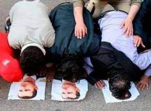 Şebbiha milisleri yakaladıkları üç direnişçiyi öldürmeden önce Esad'ın posteri üzerinde secdeye zorlarken görülüyor.