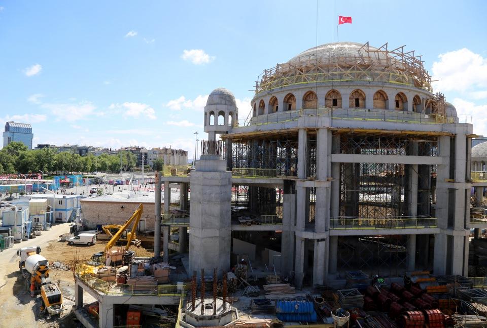 <p>Mimarlar Şefik Birkiye ve Selim Dalaman imzası taşıyan caminin, küçük iki kubbesinin ardından 28 metre çapı ve 29 metre yüksekliği olan ana kubbesinin yapımı tamamlandı. Bunun bir göstergesi olarak da kubbenin tepesine Türk bayrağı dikildi.</p>