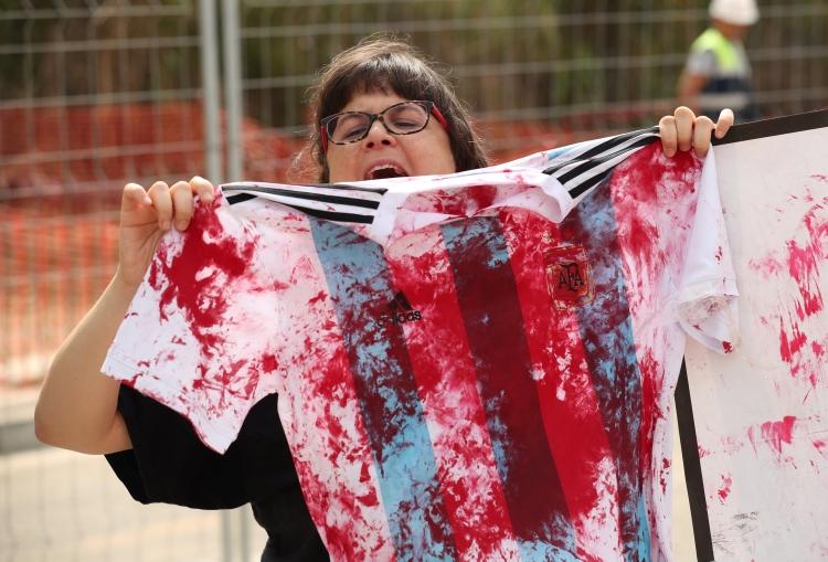 <p>Messi ve arkadaşlarının Dünya Kupası için sürdürdüğü Barcelona tesislerinin önüne gelen bir grup taraftar, Arjantin formasına temsili kan lekesi bulaştırarak antrenmanı protesto etti. </p>
