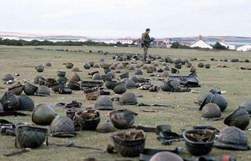 <p>Falkland Adaları'ndaki muharebelerin birinin ardından, Arjantinli askerlerin kasklarını kontrol eden İngiliz askeri,</p>

<p> </p>

<p>1982. </p>
