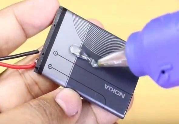 <p>Bataryanın üzerine tutkal yapıştırıyoruz ve dört tane daha eski Nokia telefonların bataryasından buluyoruz.</p>
<p> </p>