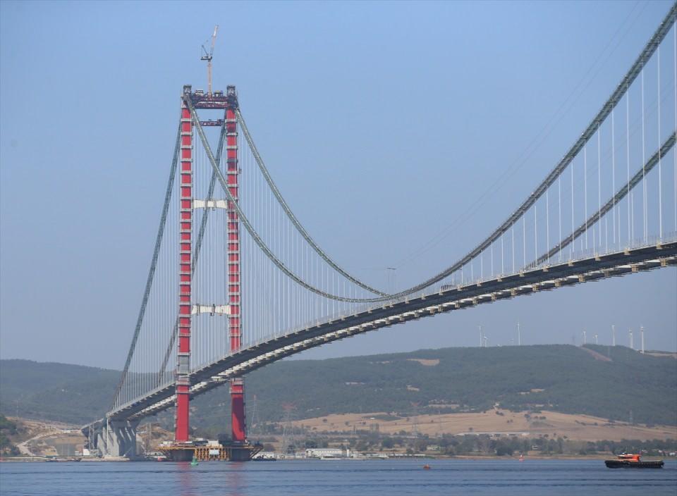 <p>İki ayak aralığına ilaveten 770'er metre yan açıklıklar, 365 ve 680 metrelik yaklaşım viyadükleriyle Çanakkale Boğazı'nın ilk asma köprüsünün uzunluğu 4 bin 608 metreyi bulacak.</p>

<p>"2x3" şeritle hizmet verecek köprünün tabliyesi 3,5 metre yüksekliğe sahip. Tabliyenin her iki tarafında inşa edilecek yürüme yolları, bakım onarım amacıyla kullanılacak.</p>

<p> </p>
