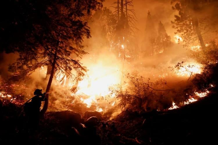 <p>28 Ağustos’ta bir itfaiyeci, California, ABD'de çıkan yangından evleri korumak için yangın söndürme ekibini yönetiyor.</p> <p> </p> 