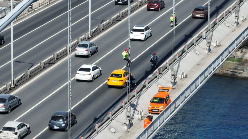 <p>Onlarca metre yükseklikte köprünün çelik halatlarına tırmanan işçiler ışıklandırma sistemlerini yeniliyor. </p>