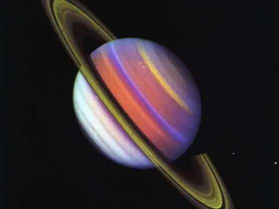 <p>1980 ve 1981'de uzay araçları Satürn'e ulaştı. Gezegenin halka yapısı, atmosferi ve uyduları hakkında gökbilimcilere eşi görülmemiş veriler sundu. Fotoğraf ultraviyole, mor ve yeşil filtrelerden geçen üç Voyager 2 görüntüsün birleştirilmesiyle elde edildi.</p>
