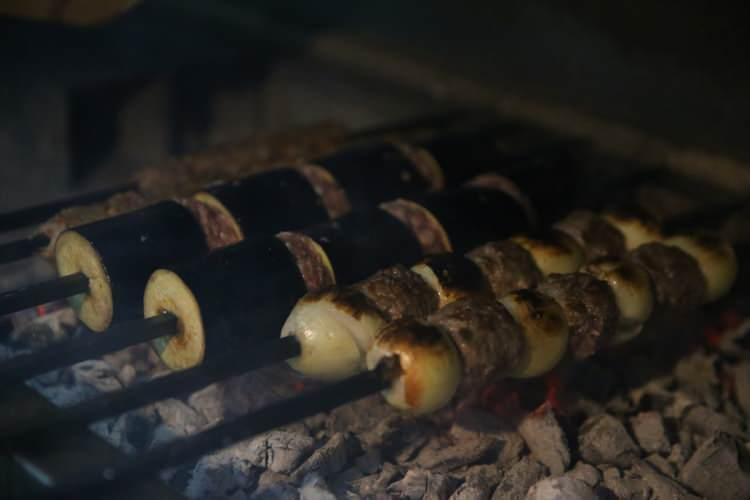 <p>Patlıcan ve soğan kebabının özelliğinin etinin yağının sebzelere geçmesinden geldiğini belirten Toğa, kazan ile tepsi kebabının ise asıl lezzetine kısık ateşte 3 saat pişerek ulaşabildiğini ifade etti.</p>