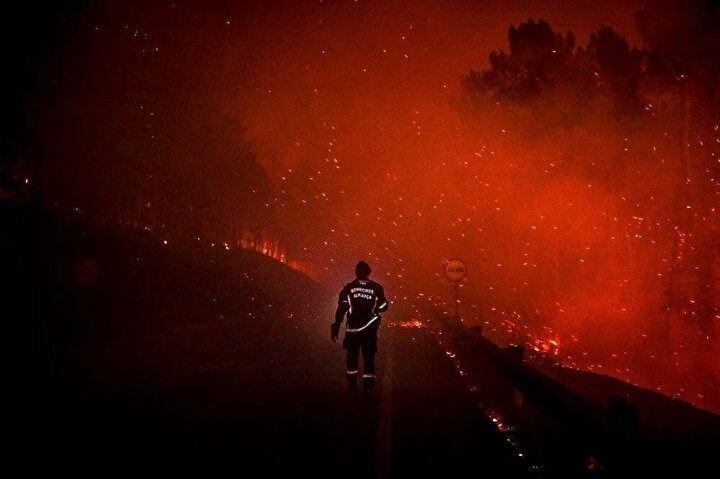 <p>Bir itfaiyeci, 10 Ağustos 2022'de Portekiz'in merkezindeki Manteigas'ta çıkan bir orman yangını sırasında el feneriyle yolda yürüyor.<br />
 </p>
