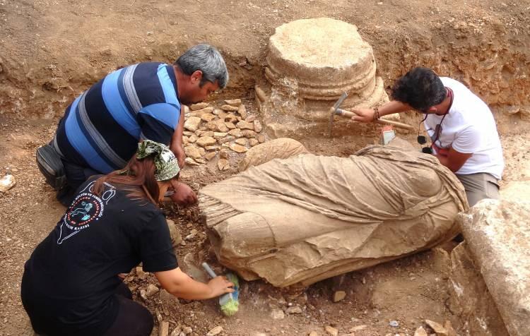 <p>Heykelin vücut bölümünün tamamen iyi korunduğu yapılan ince kazıyla ortaya çıkarıldı. Altta khiton, onun üstünde himation olmak üzere iki farklı kıyafetin işlendiği giyimli kadın heykelinin bin 800 yıl öncesine ait bir tanrıça, imparatoriçe veya burada yaşamış aristokrat yada önemli bir aileye mensup hayırsever kadınları temsil ettiği belirtildi. Yaklaşık 1500 yıl önce bölgede yaşanan büyük bir depremle toprak altında kaldığı değerlendirilen heykelin çıkarılması için ekipler gün boyu çalıştı. Son olarak ta alana vinç yanaşamaması nedeniyle heykel küçük bir iş makinesi yardımı ile Antalya Restorasyon ve Konservasyon Bölge Laboratuvarı Müdürlüğünden gelen alanında uzman bir konservatör-restoratör ve kazı ekibi tarafından büyük bir titizlikle yürütülen çalışmalar sonucunda yerinden çıkarılarak üzerinde bilimsel araştırma, temizlik, konservasyon ile restorasyon çalışmaları yapılmak üzere koruma altına alındı.</p>
