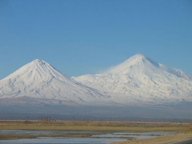 <p>Türkiye'nin en doğudaki ve en büyük volkanı olan Ağrı, Ermenistan, Azerbaycan ve İran sınırlarına yakın olduğundan farklı isimlerle bilinmektedir. Türkiye dışında yaygın olarak kullanılan ismi Ararat'tır. Ağrı'nın iki büyük volkan konisi vardır: Büyük Ağrı (daha batıda, yaklaşık 5.137 m) ve Küçük Ağrı (doğudaki koni, yaklaşık 3.896 m). Yüksek zirvesiyle Ağrı, kış aylarında çok karlı olur ve zirvesinde hızla azalan kalıcı bir buz örtüsünün altındadır.</p>
