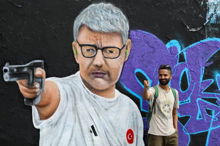 <p>Dikeç'in efsaneleşen pozu, Almanya'nın başkenti Berlin'de, bulunan Mauer Park bölgesinde duvarları süsledi. </p>