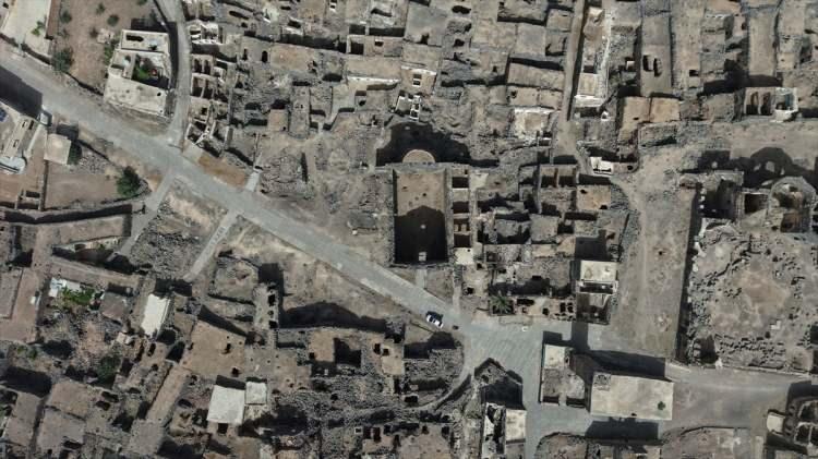 <p><strong>- Zamanda yolculuk sunuyor</strong></p>

<p>Tarih boyunca Akad, Amori, Kenan, Arami halklarının yanı sıra Roma ve Bizans gibi büyük uygarlıkların etkisi altında kalan Busra'daki tarihi yapılar, ziyaretçilerine adeta zamanda yolculuk imkanı sunuyor.</p>

<p>Bölgede Roma Tiyatrosu (antik tiyatro), Busra Kalesi, Serir Bint el-Melik Tapınağı, Zafer Kemeri, El-Hawa ve El-Nabati kapıları gibi öne çıkan tarihi yapılar yer almaktadır.</p>

<p>Busra'nın simge yapılarından Roma Tiyatrosu, İmparator Trajan döneminde 2. yüzyılda inşa ettirildi. 15 bin kişilik kapasitesi ve bazalt taş işçiliğiyle bölgenin en görkemli yapısı olmayı sürdürüyor.</p>
