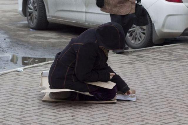 <p>Yoldan geçen insanların para verdiği kadın, kutunun içindeki paralarını saydıktan sonra...</p>
