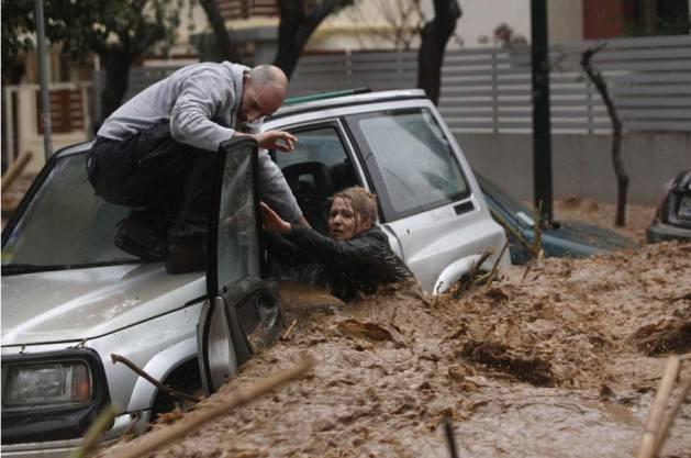 Aracı yağmur sularına kapılan bir kadının hayatta kalma m&uuml;cadelesi ise Reuters fotoğraf&ccedil;ısının objektifine kare kare yansıdı.