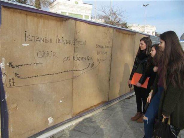 <p>Meydan dev bir şantiyeye döndü. Ana girişi kullanamayan üniversite öğrencileri, şantiyenin etrafını çevreleyen tahta levhalara okullarına nasıl gidilebileceğinin krokilerini çizdi.</p>
