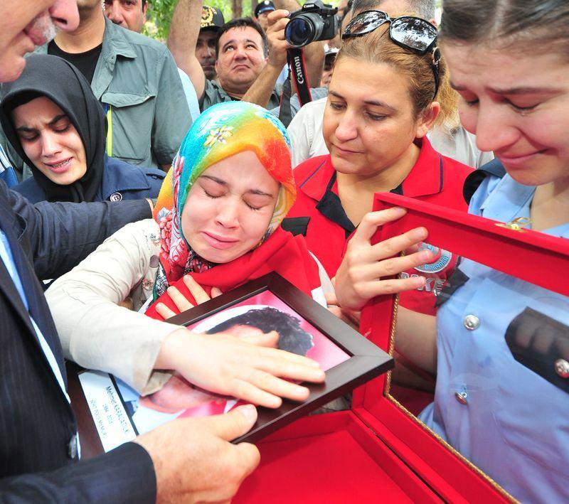 <p>FETÖ'nün darbe girişimi sırasında, Ankara Gölbaşı Özel Harekat Daire Başkanlığına yapılan saldırıda şehit olan polis memuru Mehmet Karacatilki (32) memleketi Osmaniye’de son yolculuğuna uğurlandı. Şehitin eşi Halime Karacatilki tören sonrası eşinin fotoğrafına sarılarak göz yaşı döktü. </p>