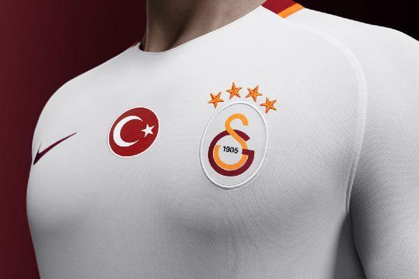 <p>Deplasman formasında yakanın arka kısmında kırmızı-sarı bir şerit yer alıyor. Formanın her iki tarafında beyaz şortla eşleşen sarı bir şerit bulunuyor. Yeni kırmızı çorapların da baldır kısmında sarı çizgisel grafik mevcut. </p>