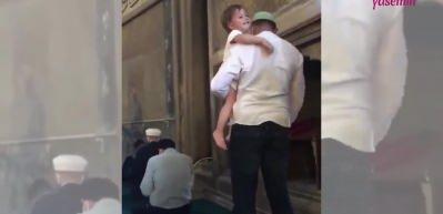 Namaz kılan babasının kucağından inmedi!