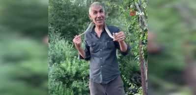Zehirli engerek yılanını yakalayıp boynuna doladı: "Benim yaptığımı yapmayın"