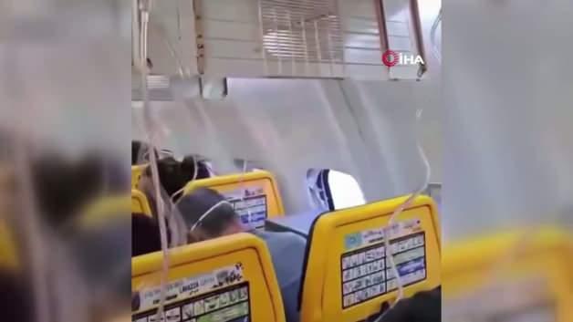 Ryanair uçağında pencerenin kopması sonucu dışarı çekilen yolcunun eşi tarafından kurtarıldığı anı gösteren temsili bir görsel.