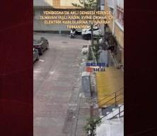 Akli dengesi yerinde olmayan yaşlı bir kadın, evine çıkmak için elektrik kablolarına tırmanıyor