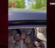 Rusya'da ilgin&ccedil; g&ouml;r&uuml;nt&uuml;: L&uuml;ks otomobiliyle odun taşıdı