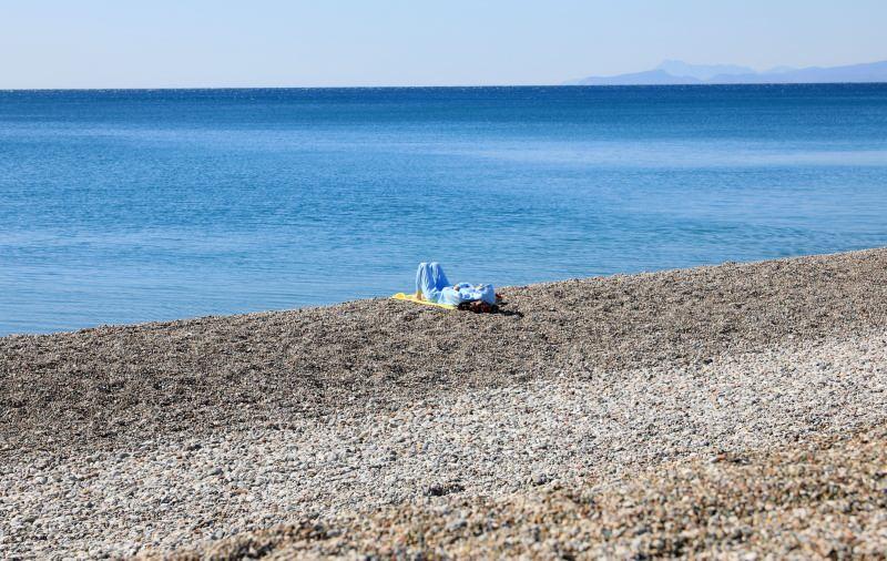 tTPCg_1618053837_3792 Konyaaltı Sahili'nde eşofmanlarıyla güneşlenen turist