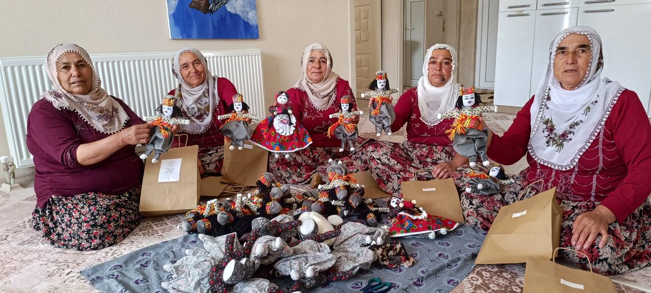 Soğanlı köyünün kadınları ördükleri bez bebekleri gösteriyor.
