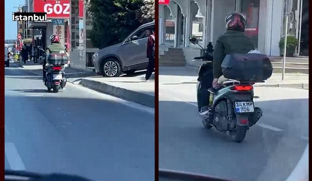 E-5&rsquo;te skandal g&ouml;r&uuml;nt&uuml;: Bebeği motosiklete lastikle bağlayıp trafiğe &ccedil;ıktı
