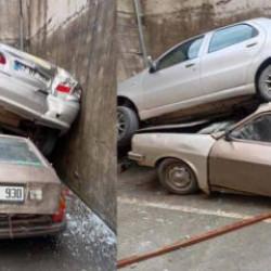 Rampadan geri kayıp 8 metrelik duvardan düştü: Park halindeki aracın üzerine çıktı