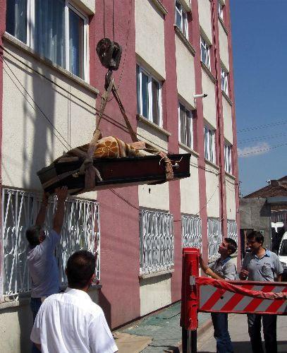 Eskişehir'de dün gece yaşamını yitiren 180 kilo ağırlığındaki güreş eski Türkiye şampiyonu Tamer Şahin'in cenazesi, kaldığı apartmanın 4. katından vinçle indirildi.
