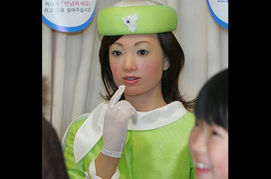 <strong>21. Teknolojinin gülen yüzü Aichi Expo'daydı</strong><br><br>
2005 -> Japon Kokoro Corp. ve Advanced Media tarafından geliştirilen bu alımlı bayan, geliştirildiği 2005 yılında insana en fazla benzeyen robot olarak objektiflere yakalnmıştı. Actroid isimli bu robotun görevi, Japonya'nın önemli fuarlarından Aichi Expo'ya gelen 120 farklı milletten ziyaretçileri bilgilendirmekti. Ve evet, doğru tahmin ettiniz. Actroid, zamanının en güzel gülen robotu olarak da tanımlanıyordu...